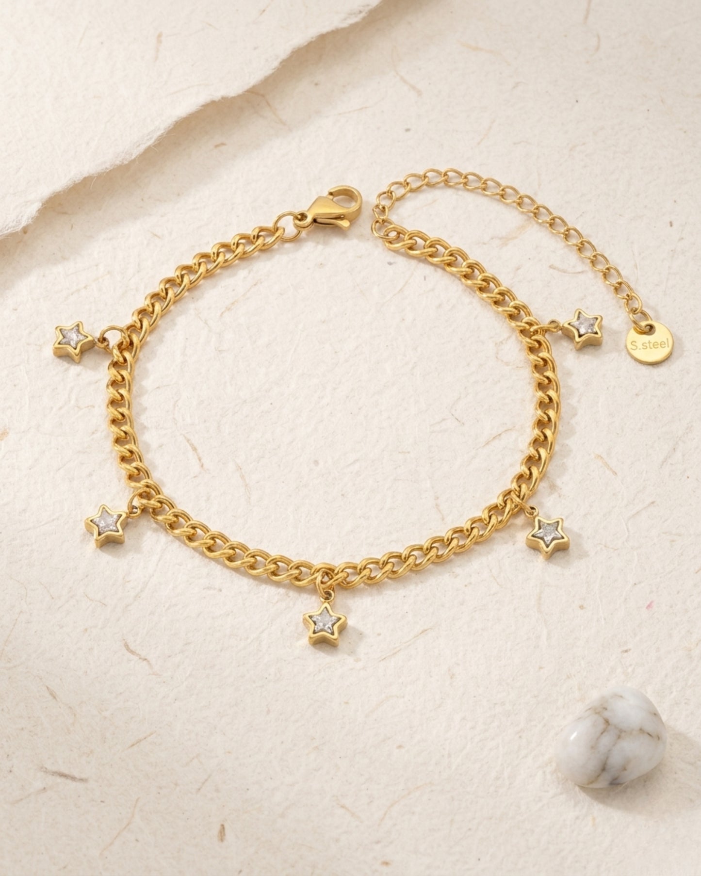 Pulsera de cadena dorada con dijes de estrella y destellos