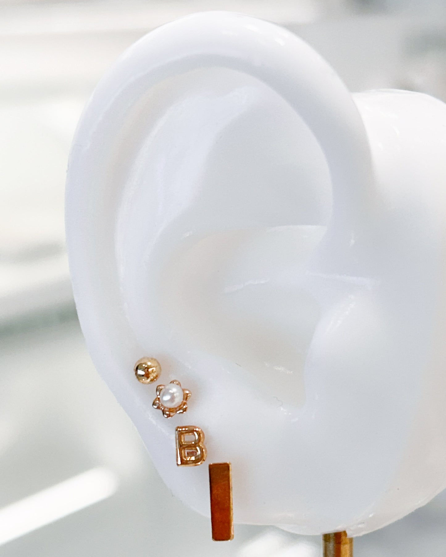 Arete tipo broquel de inicial "B" miniatura en oro 10k