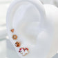 Arete tipo broquel de flor miniatura con cristales en pavé en oro 10k
