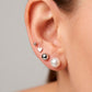 Arete tipo broquel de perla clásica con silueta esférica y brillo nacarado en oro 10k