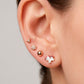 Arete tipo broquel de flor miniatura con cristales en pavé en oro 10k