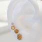 Arete tipo broquel de forma circular plana con acabado pulido en oro 10k