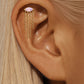 Aretes asimétricos con cristales rosados y cadenas de flecos dorados