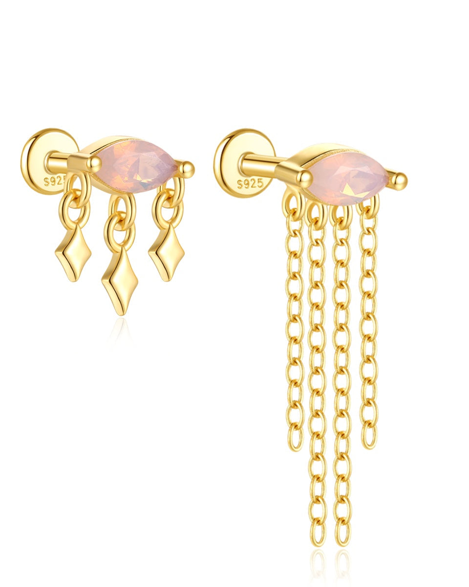 Aretes asimétricos con cristales rosados y cadenas de flecos dorados