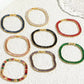 Pulsera dorada estilo tennis con circonias moradas