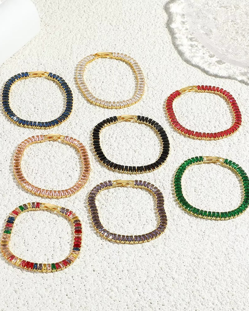 Pulsera dorada estilo tennis con circonias moradas