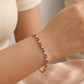 Pulsera dorada delicada estilo tennis con piedras moradas