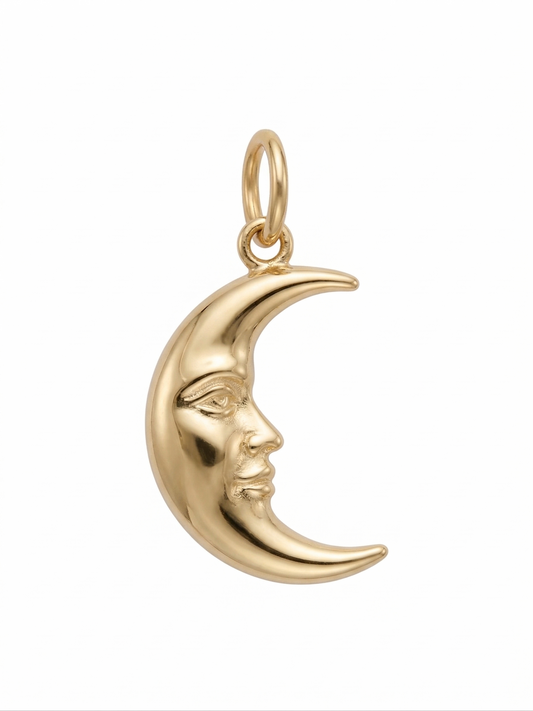 Dije de media luna creciente con rostro esculpido en oro