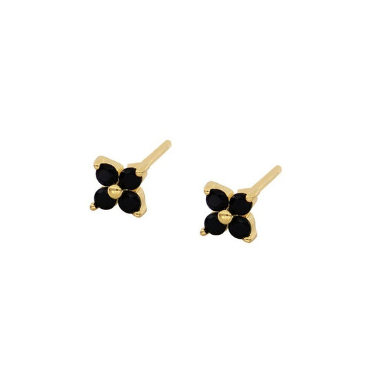 Aretes delicados dorados en color negro con forma de flor. Joyería de chapa de oro.