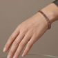 Pulsera dorada estilo tennis con circonias moradas