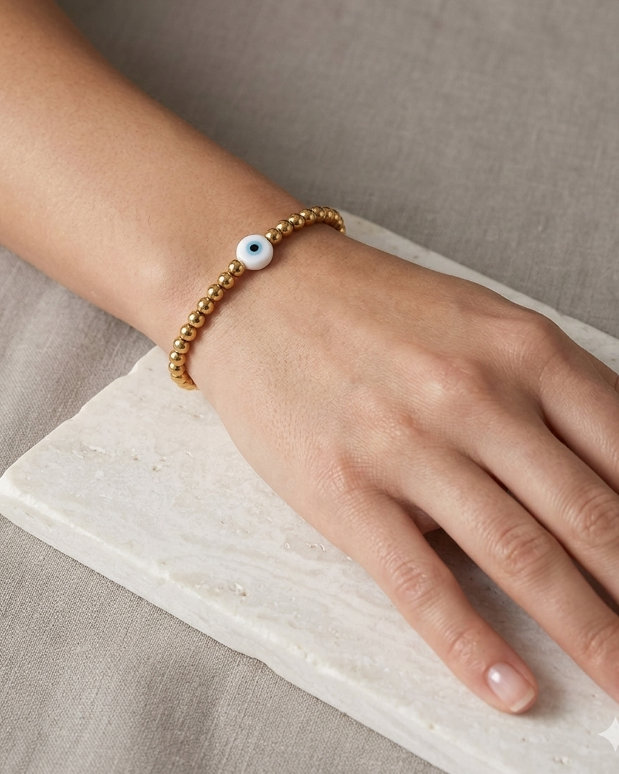 Pulsera de bolitas doradas con ojo turco