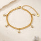 Pulsera de cadena dorada con dijes de estrella y destellos