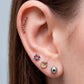 Arete tipo broquel trepadores con arco de cristales claros en oro 10k
