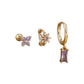 Mix de aretes dorados con diseño de mariposa, flor y piedra en tonos rosas