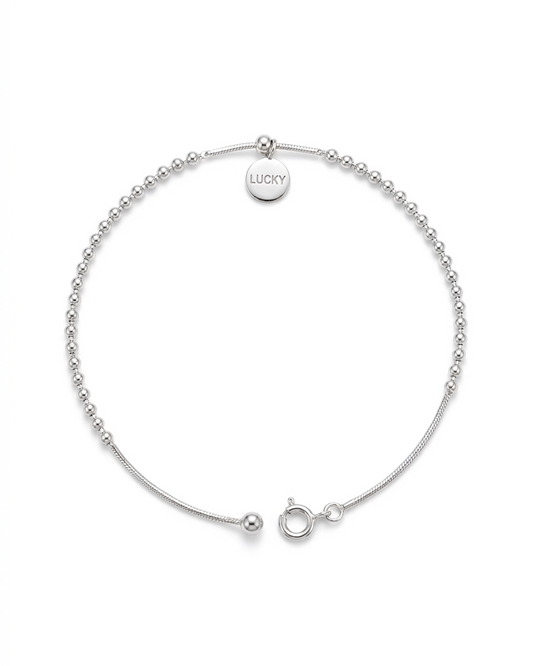 Pulsera de esferas y cordón plano con dije Lucky