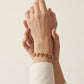 Pulsera de eslabones circulares con dijes de gota en dorado
