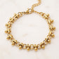Pulsera de eslabones circulares con dijes de gota en dorado