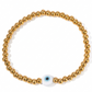 Pulsera de bolitas doradas con ojo turco