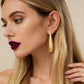 Aretes con diseño de gota, color dorado