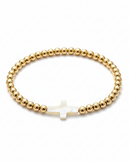 Pulsera dorada con diseño de cruz en perla