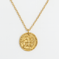 Collar dorado con cadena delgada y dije tipo moneda antigua, con relieve de perfil clásico y detalles en bajo relieve alrededor. Su diseño clásico y elegante es ideal para elevar cualquier look minimalista con un toque sofisticado y atemporal.