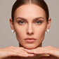 Aretes con diseño de flores blancas tipo studs dorado