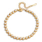 Pulsera dorada con perlas