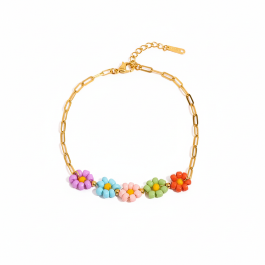 Pulsera dorada de flores en colores rojo, rosa, verde, azul.
